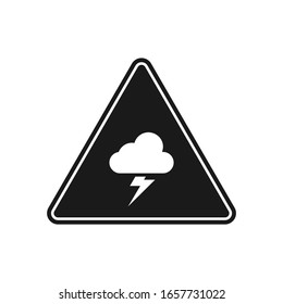 The black icon of a thunderstorm is isolated on a white background. There are cloud and lightning shapes on a triangle.
