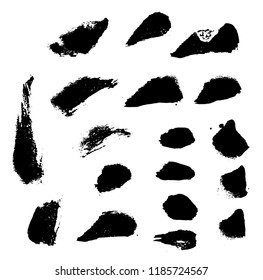 Black ink spots set on white background. Black brush strokes. Paint brush seamless background. 
