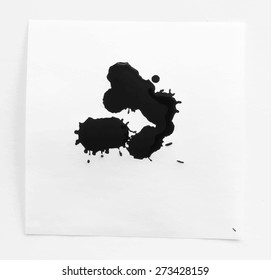 Black ink watercolor splahs, blots on white note paper