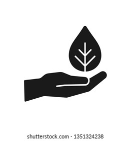Black isolated icon of hand with leaf on white background. Silhouette of hand with leaf, plant.