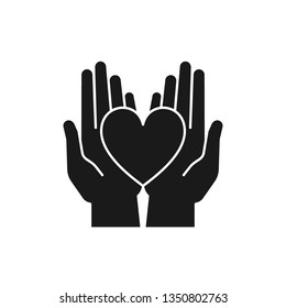Black isolated icon of heart in 2 open hands on white background. Silhouette of heart and two hands. Symbol of care, love, charity.