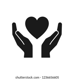 Black isolated icon of heart in hands on white background. Silhouette of heart and hands. Symbol of care, love, charity.