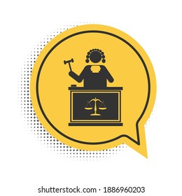 Black Judge with gavel on table icon isolated on white background. Yellow speech bubble symbol. Vector.