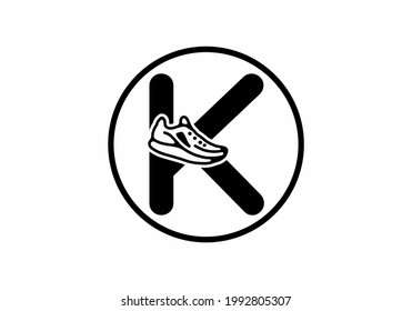 Black K initial letter with shoes in circle design
