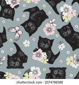 Black kitten with flowers and butterflies seamless pattern