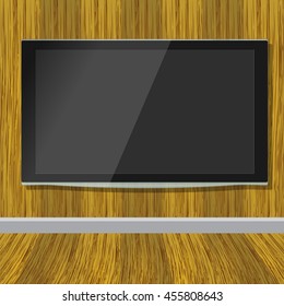 Black LCD tv screen hanging on a wooden wall