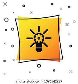 Black Light bulb with rays shine and gear inside icon isolated on white background. Innovation concept. Yellow square button. Vector Illustration