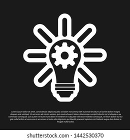 Black Light bulb with rays shine and gear inside icon isolated on black background. Innovation concept. Vector Illustration