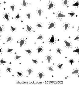 Black Light bulb with rays shine icon isolated seamless pattern on white background. Energy and idea symbol. Lamp electric.  Vector Illustration