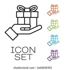 Black line Gift box in hand icon isolated on white background. Merry Christmas and Happy New Year. Set icons colorful. Vector Illustration