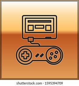 Black line Video game console with joystick icon isolated on gold background.  Vector Illustration