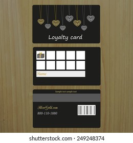 Black loyalty card on wood background. Place for your text.