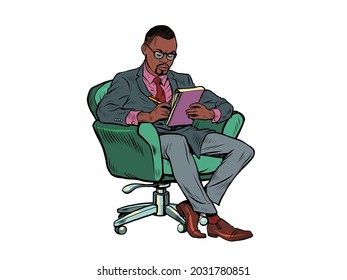 A black male psychotherapist is in a psychotherapy session, sitting in a chair and making notes in a notebook