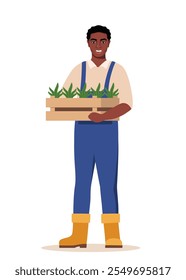 Black man farmer holding box with seedlings in hands. Farming work, gardening. Agricultural worker, Gardener, agronomist.