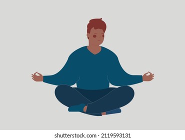 Black man meditates on the floor with closed eyes. Male or Adolescent sits with cross-legged and practices yoga. Breathing exercises in the morning. Inner peace, health care and positive body concept.