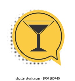 Black Martini glass icon isolated on white background. Cocktail icon. Wine glass icon. Yellow speech bubble symbol. Vector.