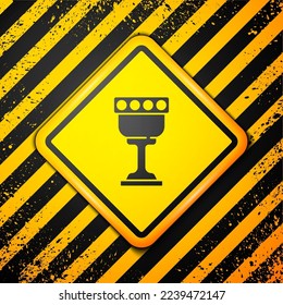 Black Medieval goblet icon isolated on yellow background. Holy grail. Warning sign. Vector