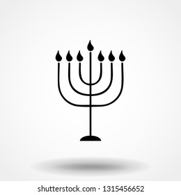 Black Menorah with burning candles is isolated on the white background is a flat vector illustration for Hanukkah. The concept is Religion icon.