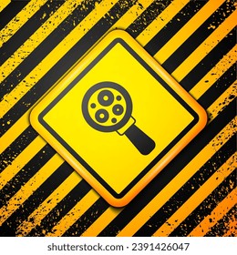 Black Microorganisms under magnifier icon isolated on yellow background. Bacteria and germs, cell cancer, microbe, virus, fungi. Warning sign. Vector