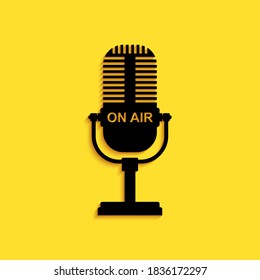 Black Microphone icon isolated on yellow background. On air radio mic microphone. Speaker sign. Long shadow style. Vector.