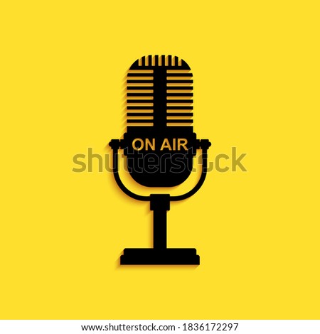 Black Microphone icon isolated on yellow background. On air radio mic microphone. Speaker sign. Long shadow style. Vector.