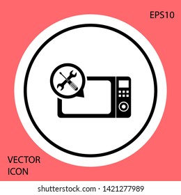 Black Microwave oven with screwdriver and wrench icon isolated on red background. Adjusting, service, setting, maintenance, repair, fixing. White circle button. Vector Illustration