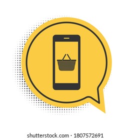 Black Mobile phone and shopping basket icon isolated on white background. Online buying symbol. Supermarket basket symbol. Yellow speech bubble symbol. Vector.