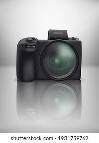 Black modern mirrorless digital camera on glass table
