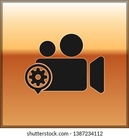 Black Movie or Video camera and gear icon isolated on gold background. Adjusting app, service concept, setting options, maintenance, repair, fixing. Vector Illustration