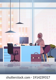 black muslim businesswoman sitting at workplace and using computer arab businesswoman working in office vertical full length vector illustration