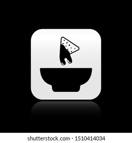 Black Nachos in plate icon isolated on black background. Tortilla chips or nachos tortillas. Traditional mexican fast food. Silver square button. Vector Illustration