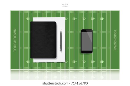 Black notebook cover and blank screen smartphone with football field background. Vector abstract background for american sport.