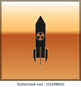 Black Nuclear rocket icon isolated on gold background. Rocket bomb flies down.  Vector Illustration