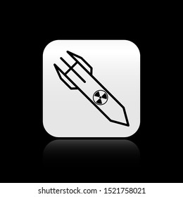Black Nuclear rocket icon isolated on black background. Rocket bomb flies down. Silver square button. Vector Illustration