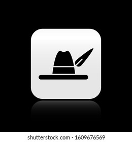 Black Oktoberfest hat icon isolated on black background. Hunter hat with feather. German hat. Silver square button. Vector Illustration