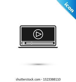 Black Online play video icon isolated on white background. Laptop and film strip with play sign.  Vector Illustration