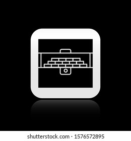 Black Opened antique treasure chest icon isolated on black background. Vintage wooden chest with golden coin. Silver square button. Vector Illustration