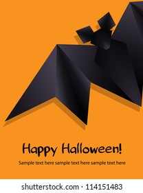 Black origami bat on orange background. Halloween background.