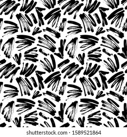 Black painted brush strokes seamless vector pattern. Black brushstrokes on a white background. Scribble smears wallpaper, wrapping paper, fabric. Modern ink illustration. Abstract rough texture. 