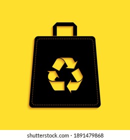 Black Paper shopping bag with recycle icon isolated on yellow background. Bag with recycling symbol. Long shadow style. Vector.
