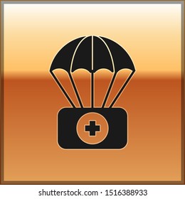 Black Parachute with first aid kit icon isolated on gold background. Medical insurance.  Vector Illustration