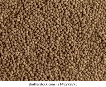 Black peppercorns. Aromatic spice for food. Realistic vector illustration of a background of dried black pepper seeds on a wooden kitchen board with a measuring spoon.
