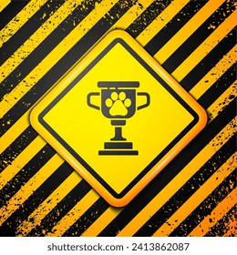 Black Pet award symbol icon isolated on yellow background. Medal with dog footprint as pets exhibition winner concept. Warning sign. Vector