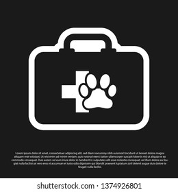 Black Pet first aid kit icon isolated on black background. Dog or cat paw print. Clinic box. Vector Illustration