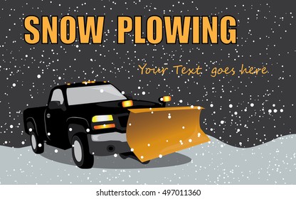 Black pick up truck with snow plow n a snow storm