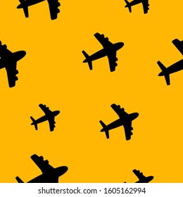 black plane on a yellowbackground. Cute seamless background.