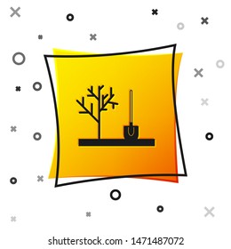 Black Planting a tree in the ground icon isolated on white background. Gardening, agriculture, caring for environment. Yellow square button. Vector Illustration