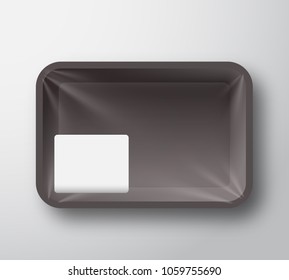 Black Plastic Food Tray Container with Transparent Cellophane Cover and Clear White Sticker Label Template in a Corner. Realistic Packaging Mock Up. Isolated.