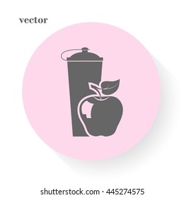 black plastic vitamin shaker and apple,