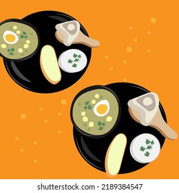Black plates with soup, sour cream, bread and meat on orange background.